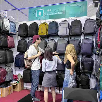 Wall of colourful backpacks at the SANDA exhibition booth, with buyers browsing