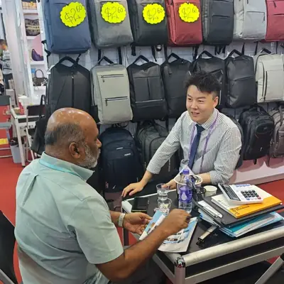 SANDA staff assisting a buyer at the booth counter