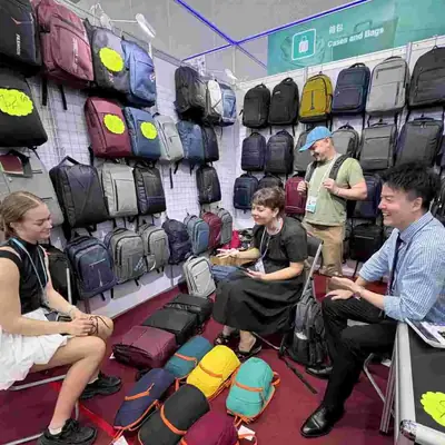 Buyers seated with SANDA staff at a booth table during a trade show