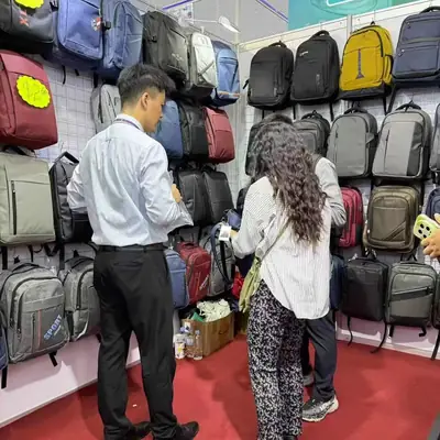 SANDA team member helping buyers at the booth's bag display